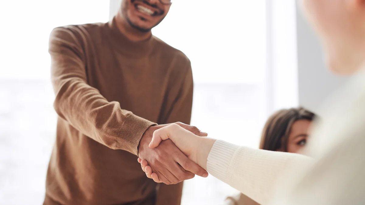 Man shaking woman's hand in the office